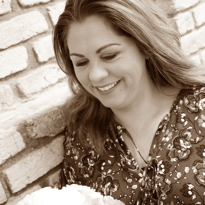 Sepia toned Portrait of Judi, holding white flower bouquet.